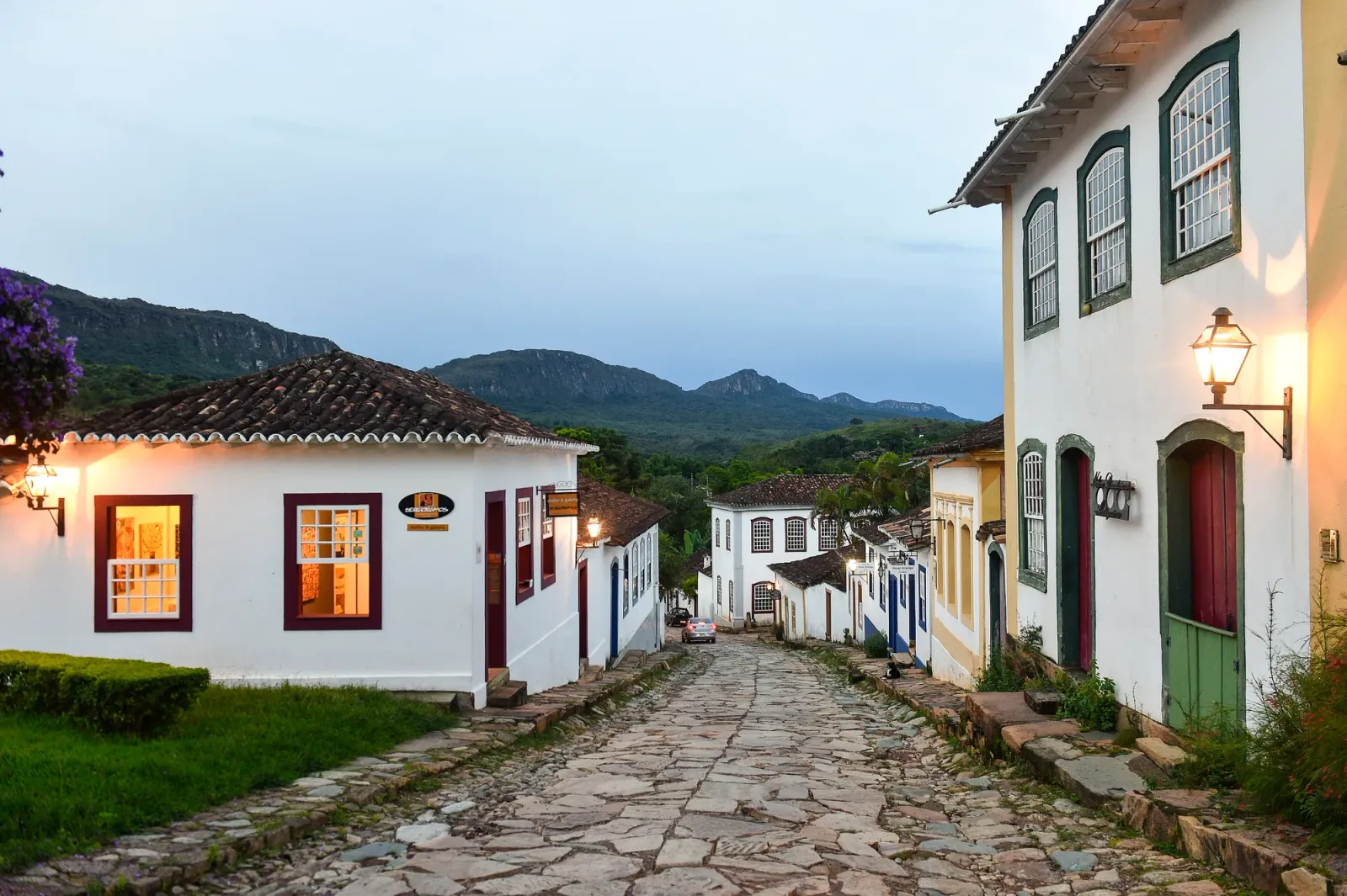 Rua de pedra de Tiradentes ladeada por sobrados caiados, com a Serra de São José ao fundo